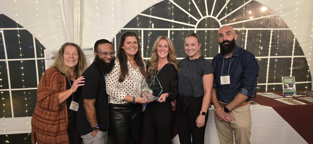 The MAX Fitness & Wellness Hillsborough team posing and smiling around Athletic Excellence award